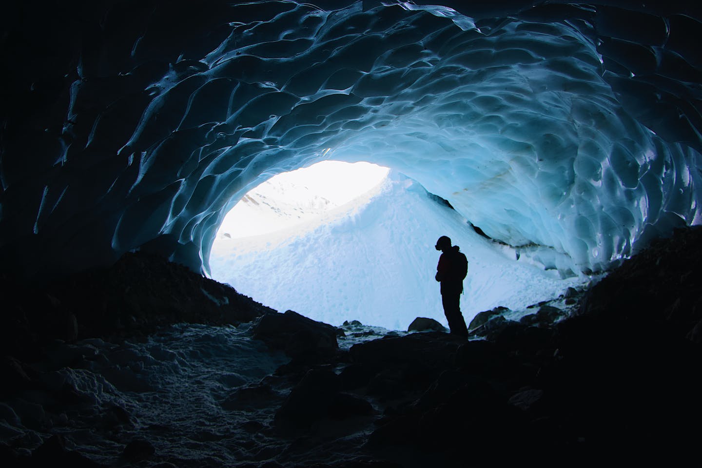 Silhouette Photo of Person Standing in Cave
