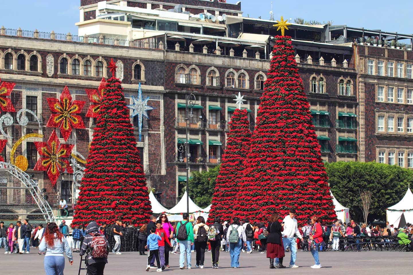 Colorful Christmas display with festive trees in Mexico City's Zocalo, capturing the holiday spirit.