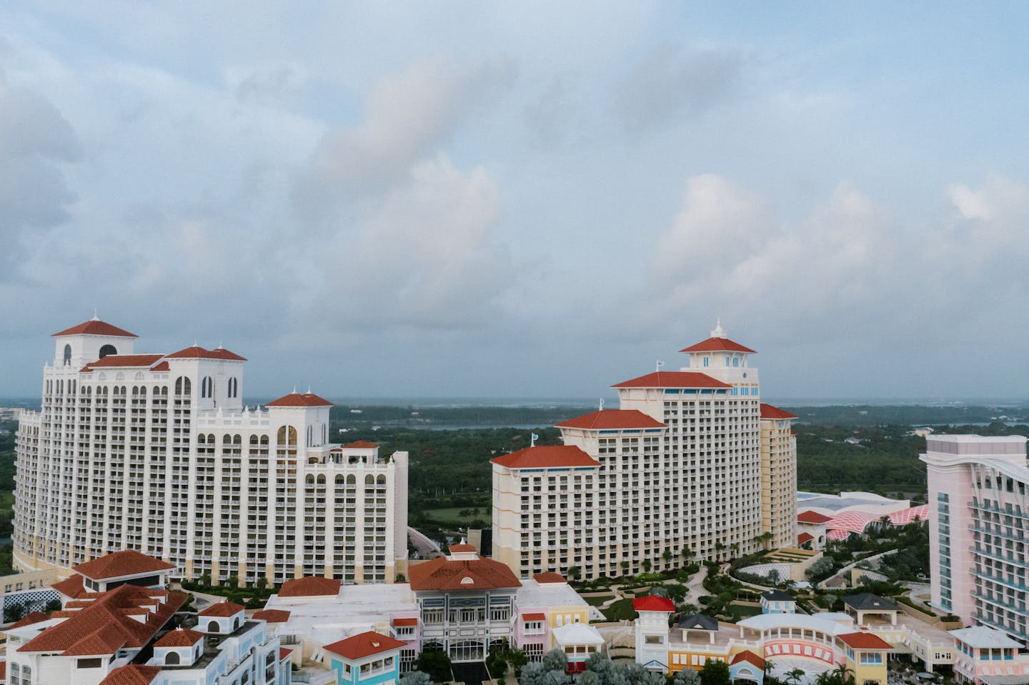 Aerial view of a luxurious resort with red roofs and modern architecture in the Bahamas.