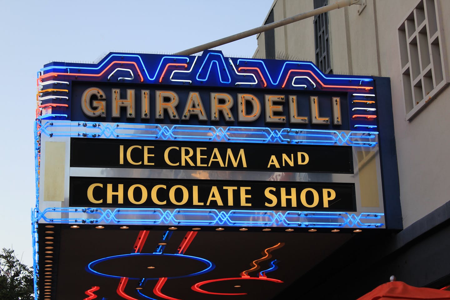 Colorful neon sign of Ghirardelli Ice Cream and Chocolate Shop in San Diego.