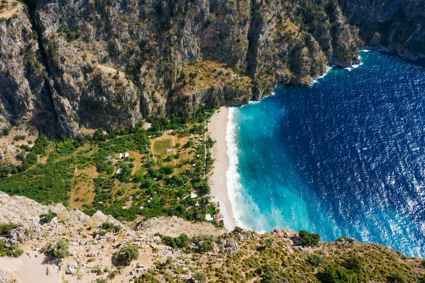 Breathtaking aerial shot of Butterfly Valley's turquoise waters and rugged coastline.
