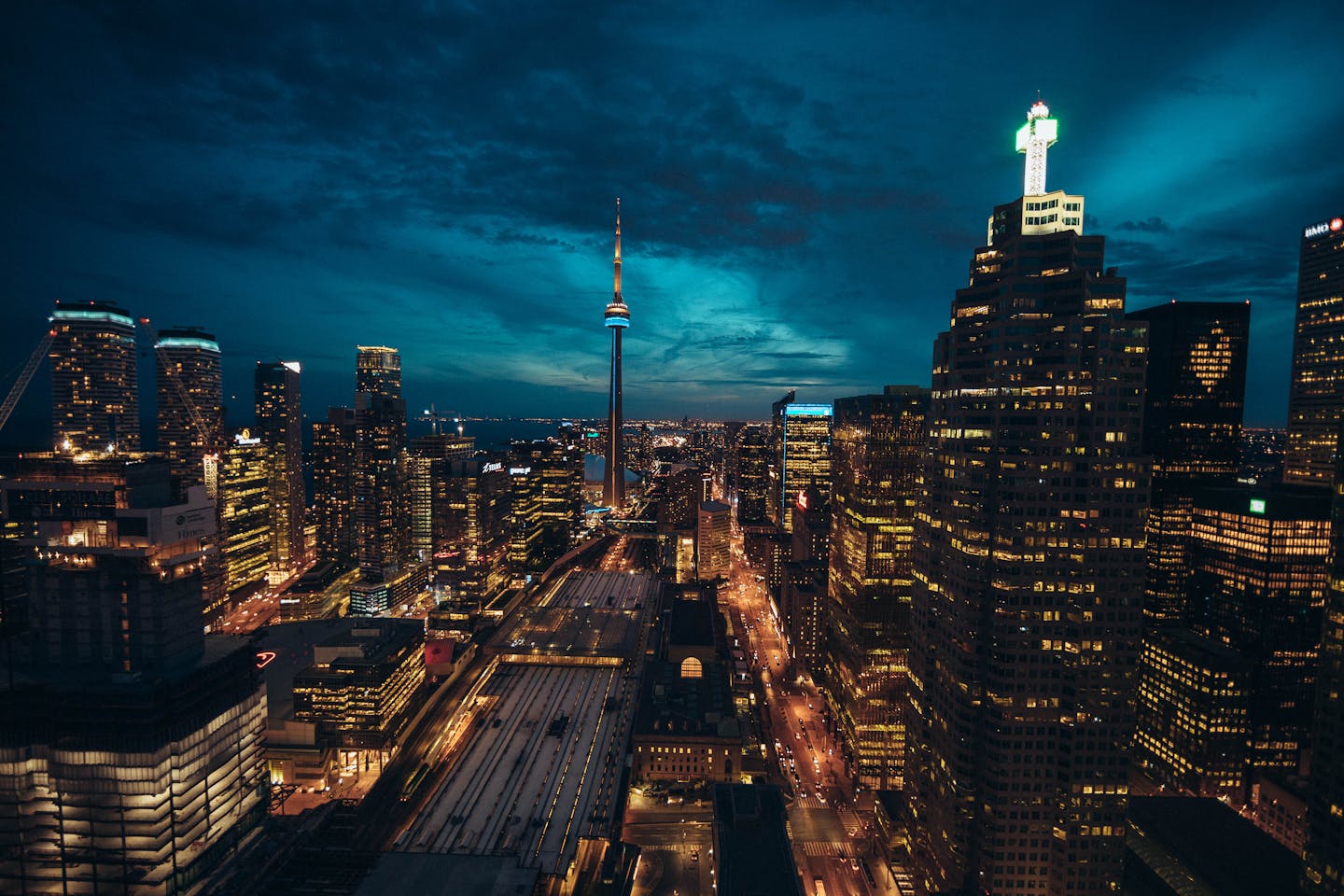 Stunning Toronto cityscape at night featuring the illuminated CN Tower and vibrant urban skyline.