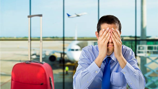crying businessman who delayed flight at an airport