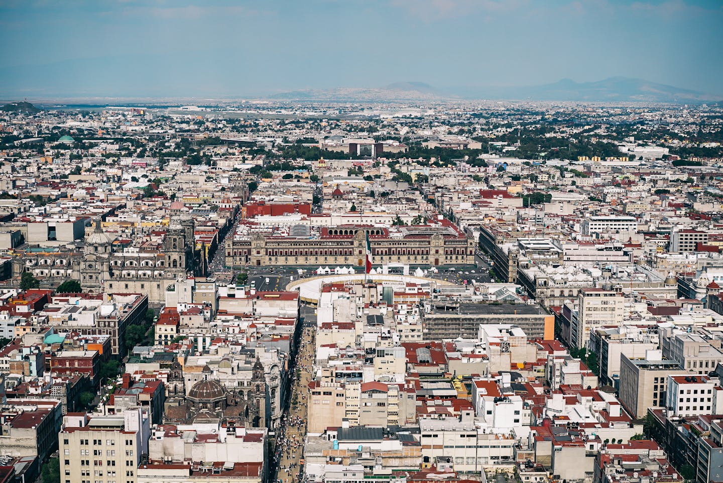 Aerial view capturing the sprawling urban landscape of Mexico City with historic architecture.