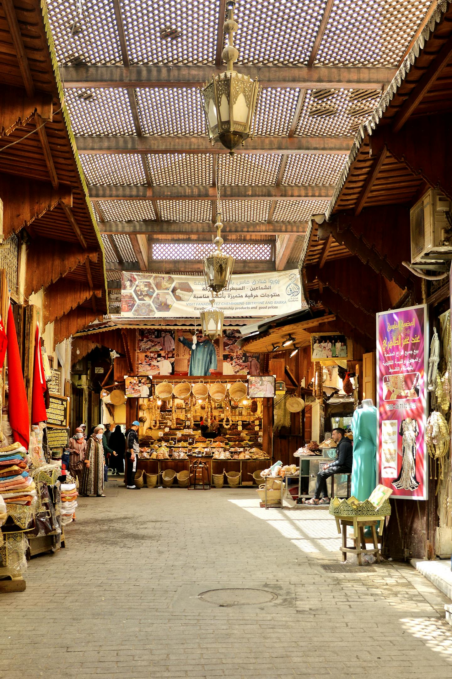 Explore the bustling markets of Fès with traditional goods and vibrant colors.
