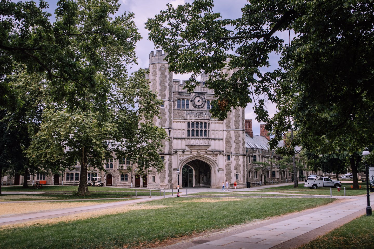 Explore the iconic gothic architecture of Princeton University, surrounded by lush greenery.