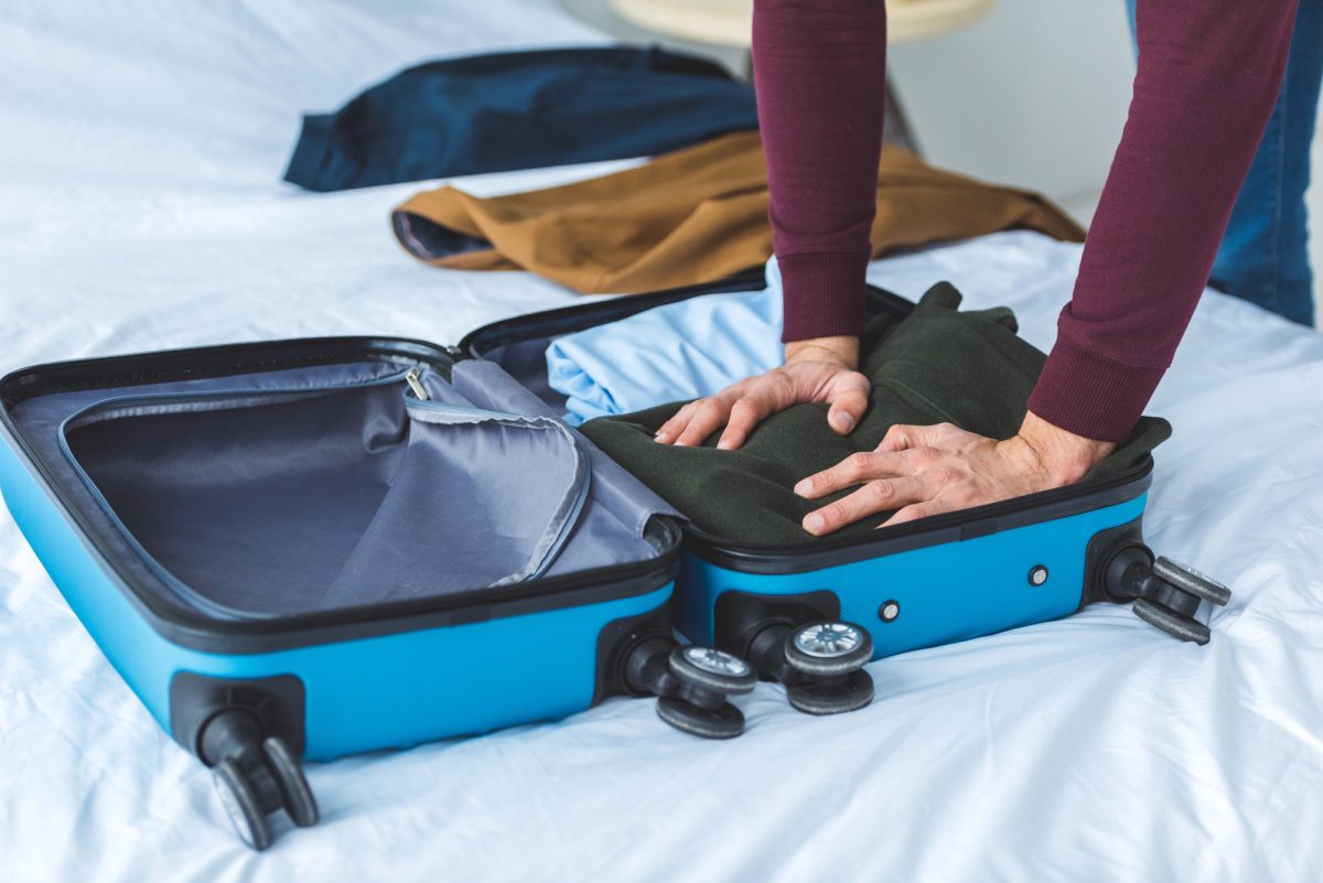 how to roll clothes to pack suitcases