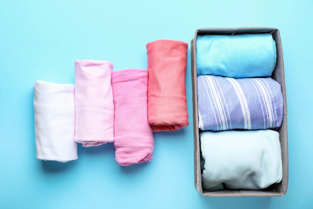 how to roll clothes to pack suitcases